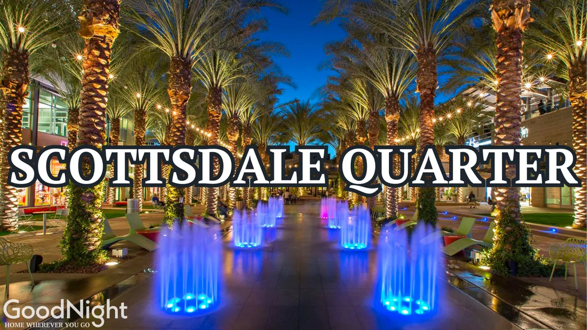 A festive evening scene with colorful water fountains, palm trees, and illuminated pathways bustling with people. The lighting and design evoke the vibrant ambiance of an upscale shopping and dining destination, hinting at community events, nightlife, and social gatherings.